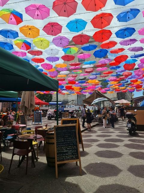 A street in Catania under colourful umbrellas